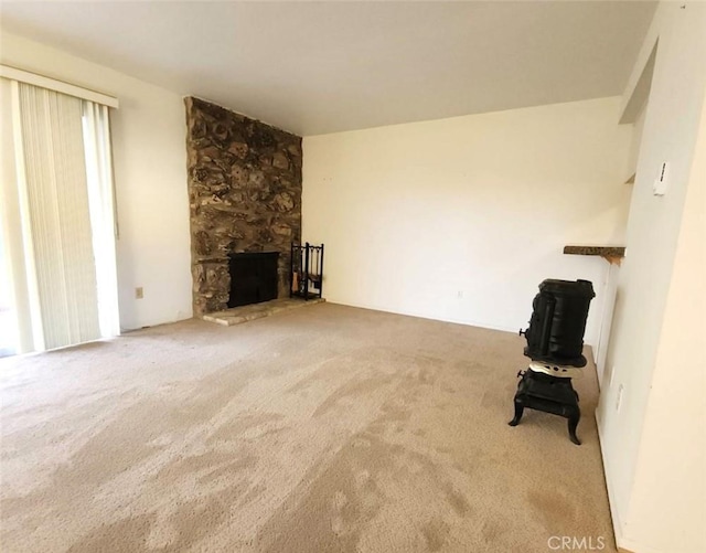 unfurnished living room featuring carpet flooring and a fireplace