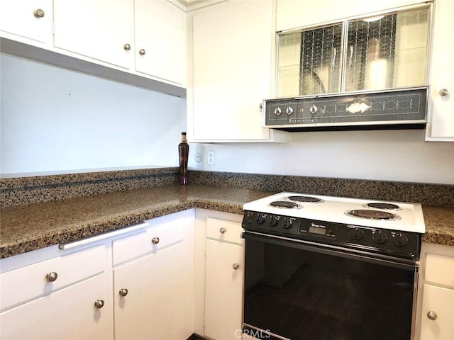 kitchen featuring dark countertops, white cabinetry, and black electric range