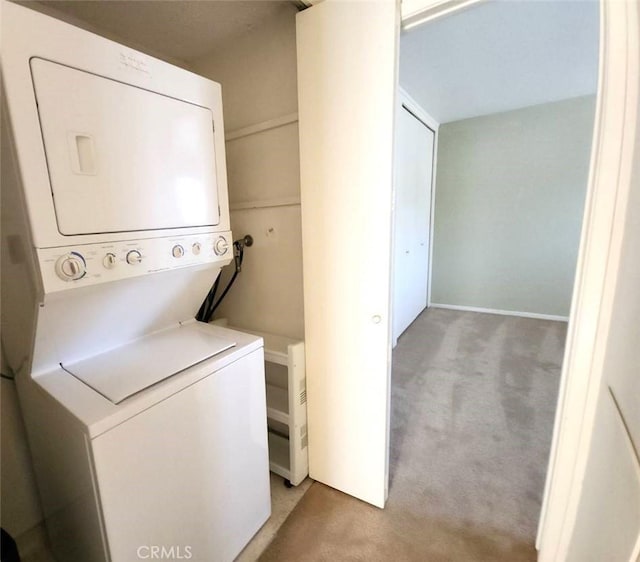 washroom with laundry area, stacked washer and clothes dryer, and light carpet