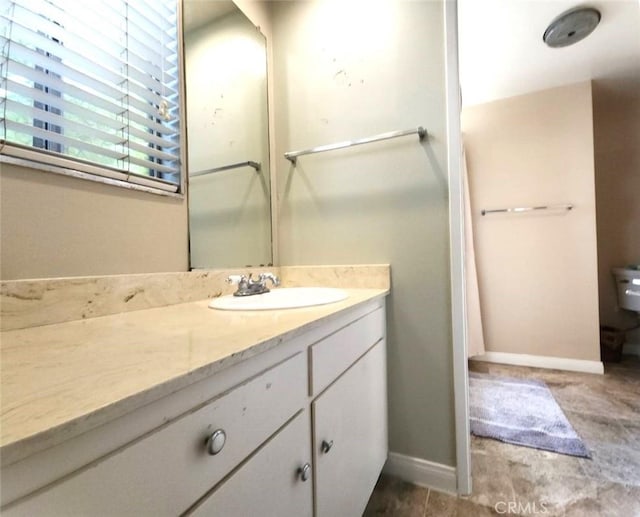 bathroom with vanity and baseboards