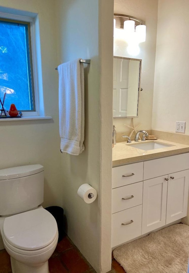 bathroom featuring toilet and vanity