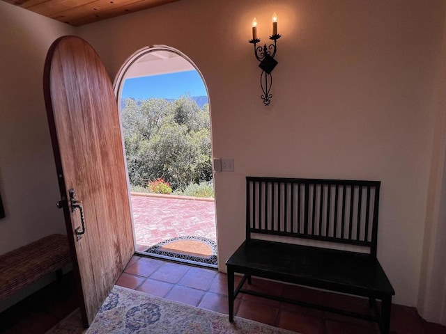 tiled entryway with wooden ceiling