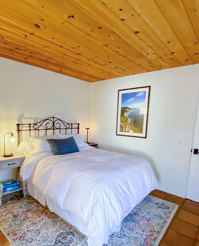 bedroom with wood ceiling and hardwood / wood-style floors