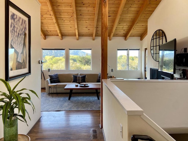 interior space featuring vaulted ceiling with beams, wood ceiling, and dark hardwood / wood-style floors