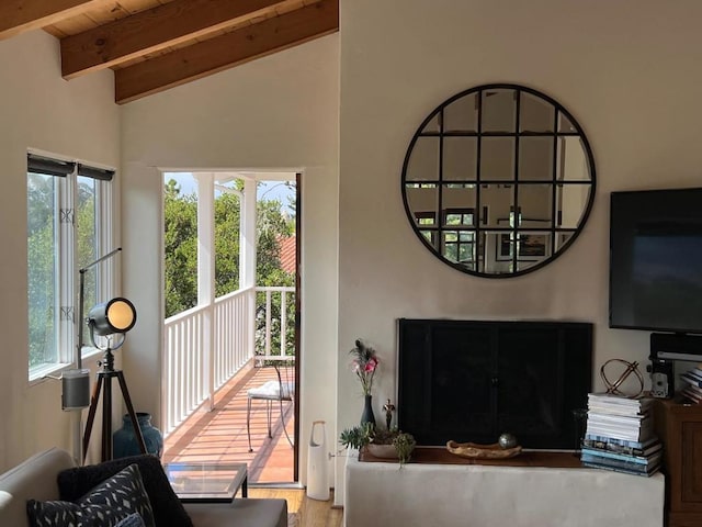 living room featuring light hardwood / wood-style flooring, lofted ceiling with beams, and wood ceiling