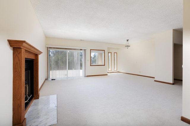 unfurnished living room with light colored carpet and a textured ceiling