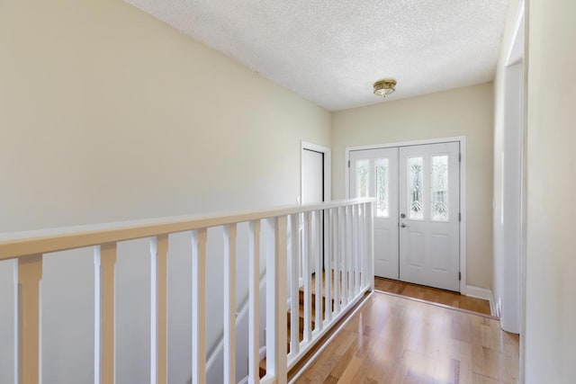 entrance foyer featuring a textured ceiling and light hardwood / wood-style flooring