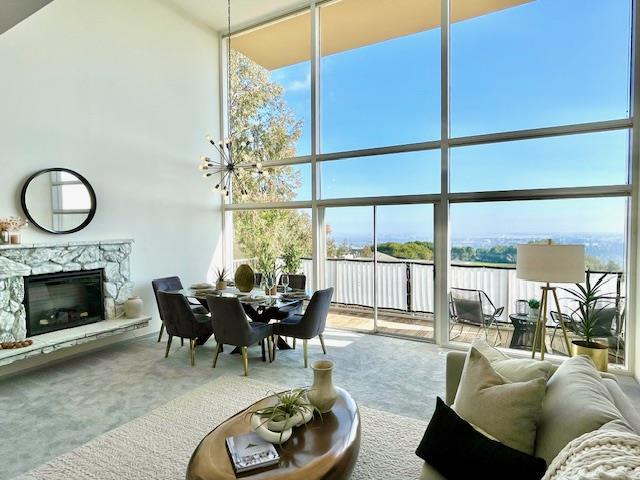 sunroom featuring a stone fireplace