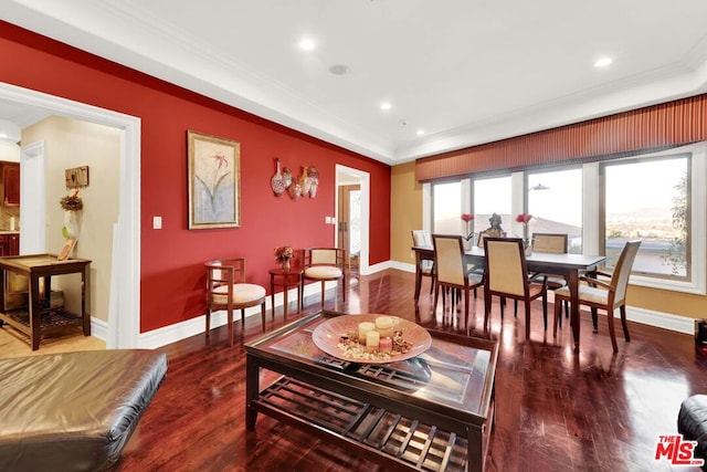 living room featuring dark wood-type flooring and ornamental molding