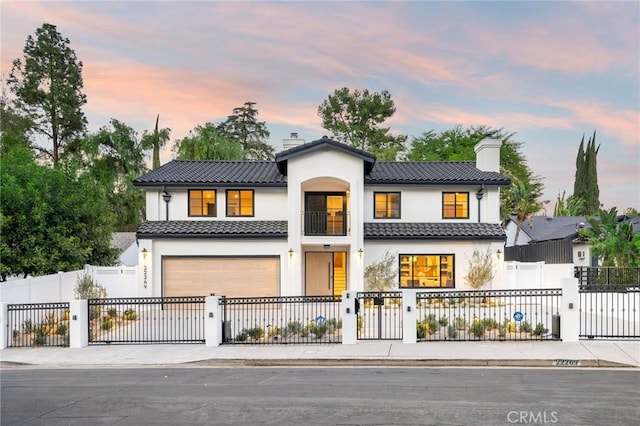 mediterranean / spanish-style house with a garage