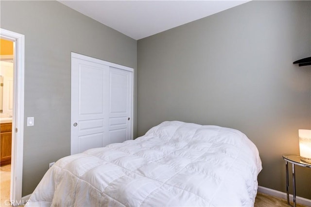 bedroom featuring a closet and light colored carpet