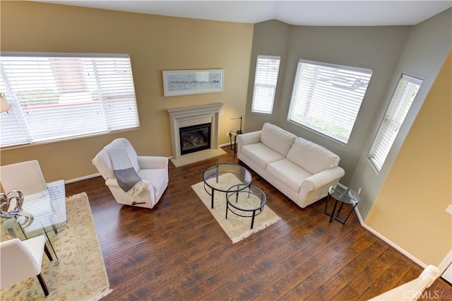 living room featuring dark hardwood / wood-style floors and vaulted ceiling