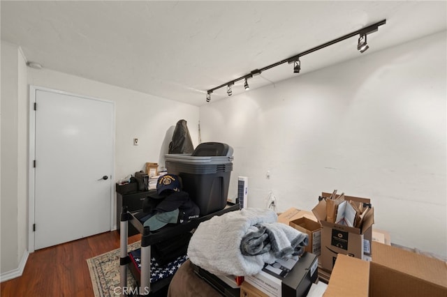 interior space featuring dark wood-type flooring and track lighting