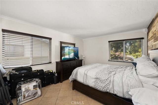 bedroom with a textured ceiling, light tile patterned floors, and crown molding