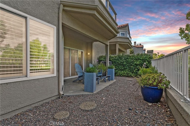 yard at dusk with a patio area and fence