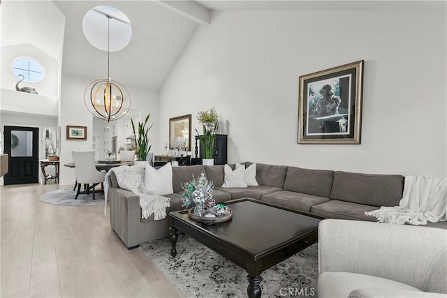 living room featuring light wood-type flooring, an inviting chandelier, beamed ceiling, and high vaulted ceiling