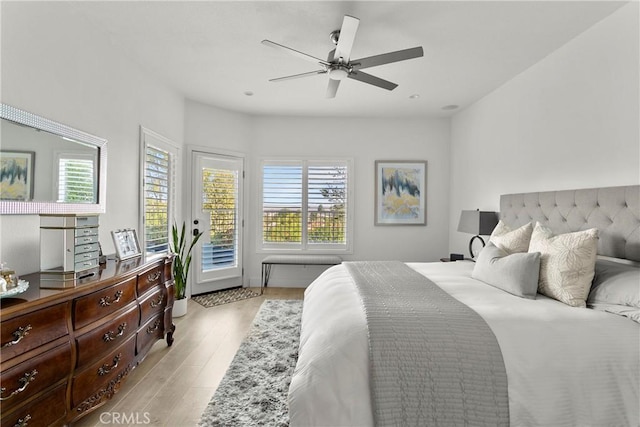 bedroom featuring access to outside, ceiling fan, and light wood-style flooring