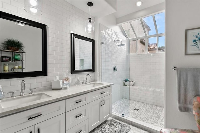 bathroom featuring a shower with shower door, vanity, tile walls, and tasteful backsplash