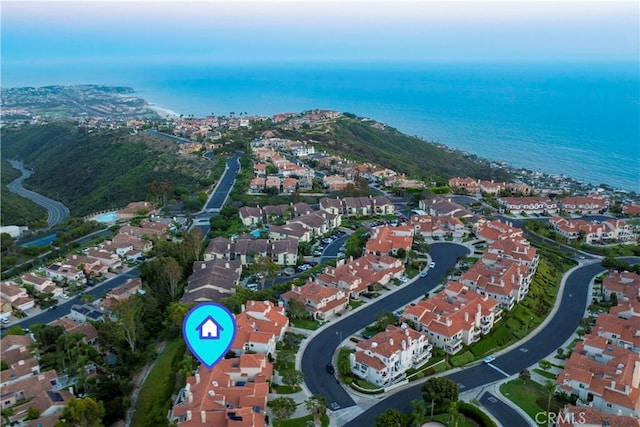 birds eye view of property with a water view and a residential view