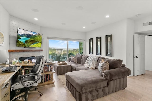 living area featuring recessed lighting, visible vents, and light wood-style floors