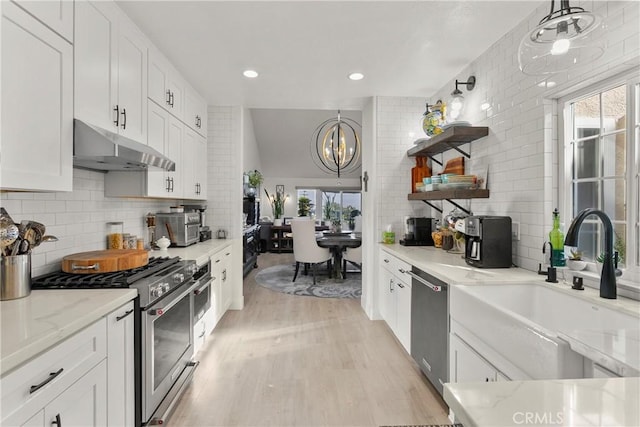 kitchen with pendant lighting, open shelves, appliances with stainless steel finishes, white cabinets, and under cabinet range hood