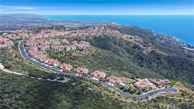 drone / aerial view featuring a water view and a residential view