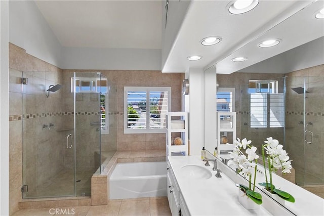 bathroom featuring vanity, independent shower and bath, and tile patterned floors