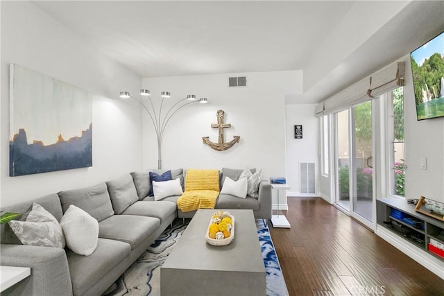 living area featuring baseboards, visible vents, and dark wood finished floors