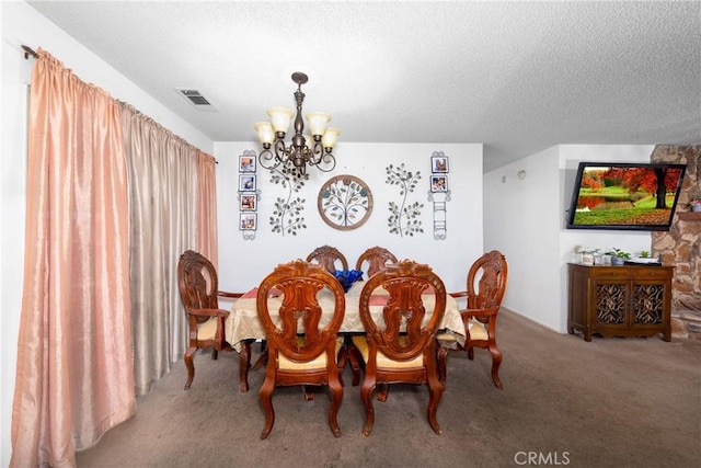 dining area with a textured ceiling, carpet flooring, and an inviting chandelier