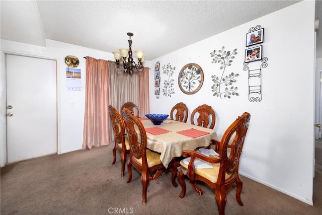 dining space with a textured ceiling, an inviting chandelier, and carpet floors