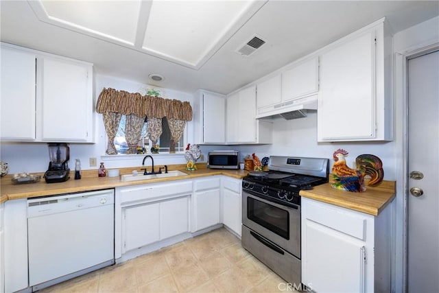 kitchen with stainless steel appliances, white cabinets, and sink