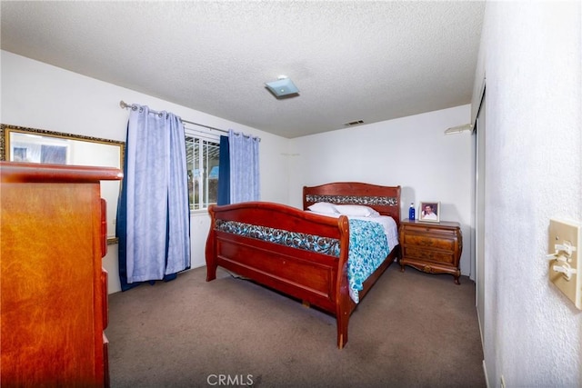 carpeted bedroom with a textured ceiling