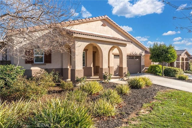 mediterranean / spanish home featuring a garage