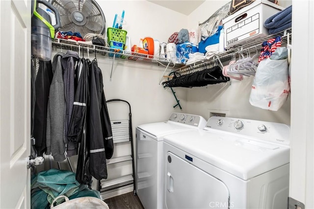 laundry room with washer and clothes dryer and dark hardwood / wood-style flooring