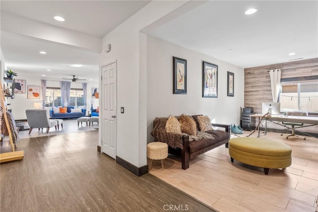 living room featuring ceiling fan and wood-type flooring