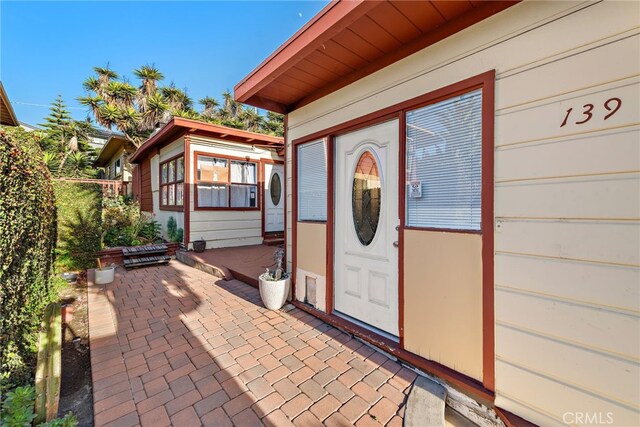 doorway to property with a patio area