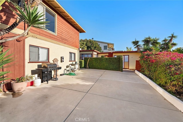 view of home's exterior with a patio and stucco siding