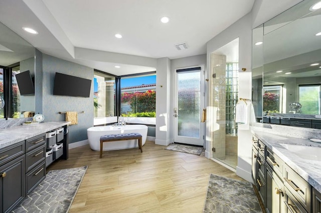 bathroom featuring vanity and shower with separate bathtub