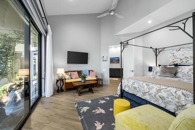 bedroom featuring ceiling fan, lofted ceiling, and light hardwood / wood-style flooring