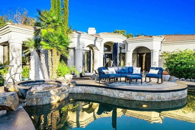 rear view of house with outdoor lounge area