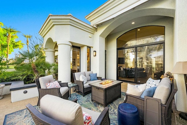 view of patio / terrace featuring an outdoor living space with a fire pit