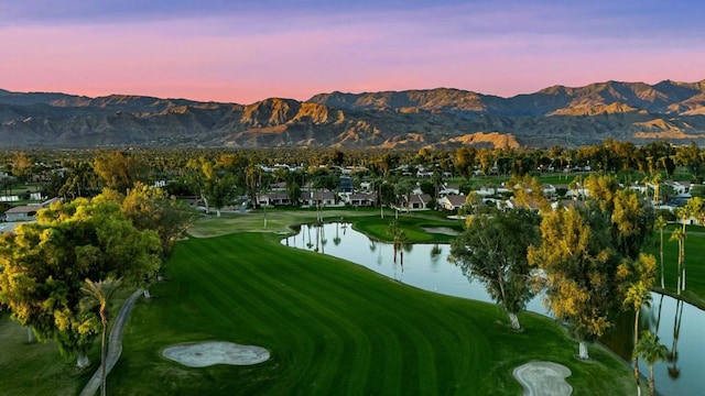 view of community with a water and mountain view and a lawn