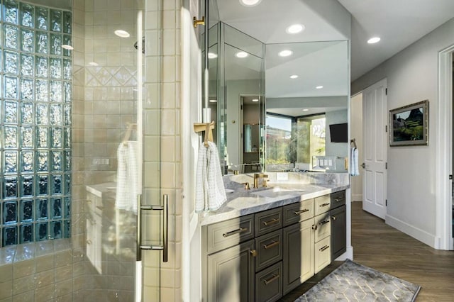 bathroom with vanity, wood-type flooring, and walk in shower