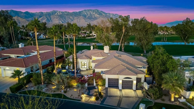 aerial view at dusk with a water and mountain view