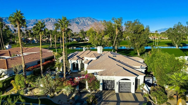 birds eye view of property featuring a water and mountain view