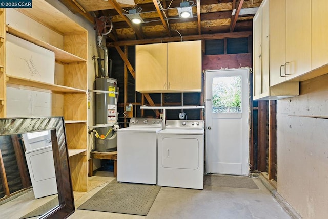 laundry room featuring cabinets, strapped water heater, and washing machine and clothes dryer