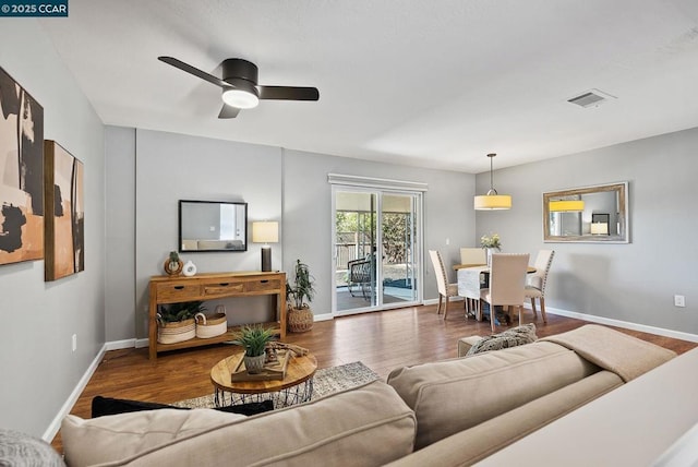 living room featuring ceiling fan and wood-type flooring