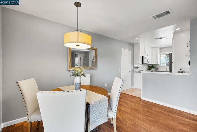 dining area with light hardwood / wood-style floors