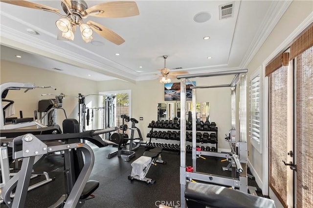 exercise room featuring ceiling fan, ornamental molding, and a healthy amount of sunlight