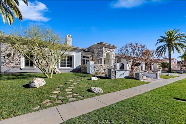 view of front facade with a front yard and area for grilling